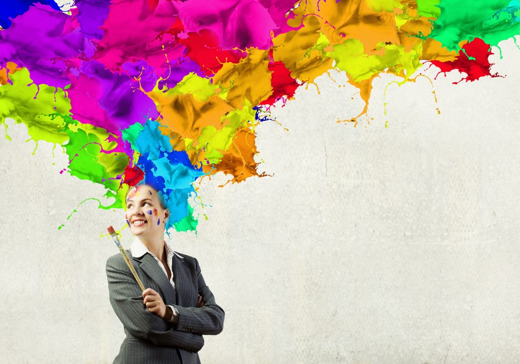 Thoughtful businesswoman with colorful splashes out of his head